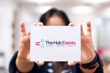 Person holding up a The Hub Events business card